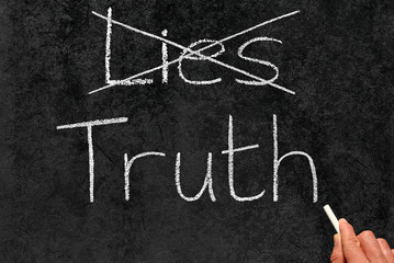 Crossing out Lies and writing Truth on a blackboard.