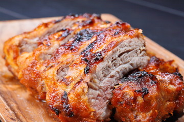 Grilled pork ribs on wooden plate