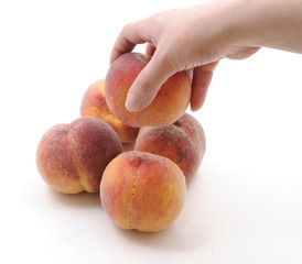 Hand holding a peach