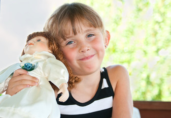 Little girl playing with a doll