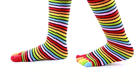 woman legs in strip sock on white background