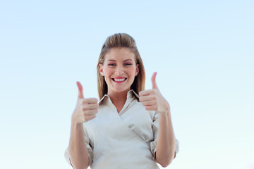 Businesswoman smiling at the camera with thumbs up