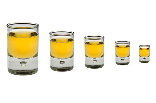 row of 5 whiskey glasses on white
