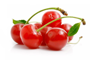 fresh red cherries with green leaves