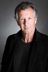 Obraz premium Handsome Senior Man against a Grey Background