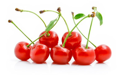 fresh red cherries with green leaves
