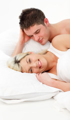 Fototapeta na wymiar Happy girl with her boyfriend lying in bed