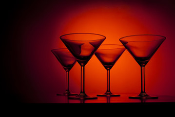 martini glasses over red background