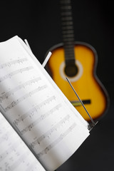 Musical chords and guitar on background