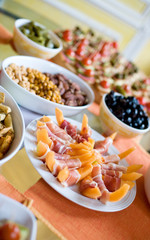 Appetizers. Melon with ham, nuts, canapes and black olives