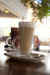 coffee latte and hot chocolate in tall glasses on cafe backgroun