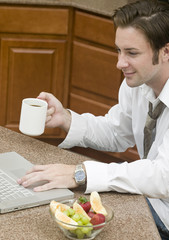 A young businessman having breakfast before he goes to work