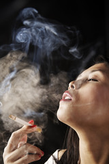 Fototapeta premium Female inhale smoke from cigarette