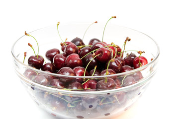 red cherries in a bowl isolated on white