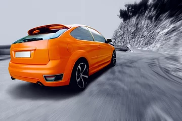 Muurstickers Beautiful orange sport car on road © Andrii IURLOV
