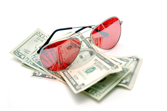 Red sunglasses resting on cash