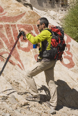 Hiker resting with a buddhist wallpaint