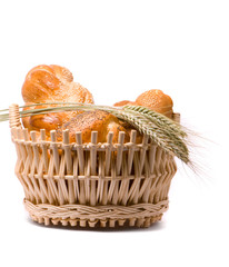 Fresh baked rolls in a basket on white