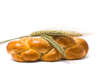Single fresh bun and ear of wheat