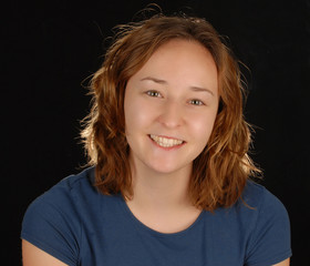 attractive happy young woman on black background