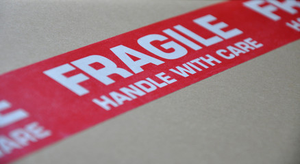 Cardboard with a large red label with text 'fragile handle with care'