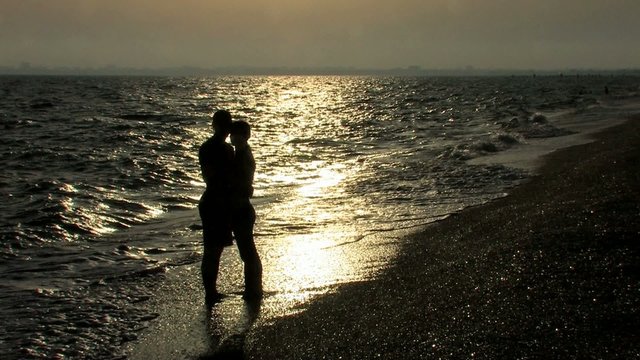 HD young couple kissing on the seashore