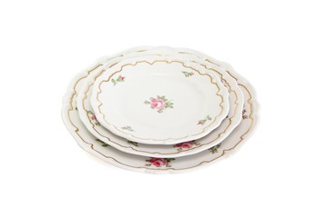 Stack of three white dinner and saucers with flowers isolated