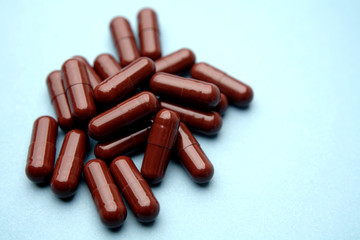 Brown capsules on blue background