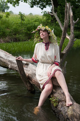 girl  in flower chaplet at river