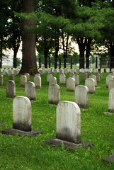 Old white tombstones in a cemetery.