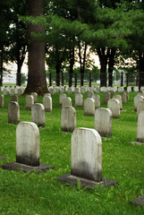 Naklejka premium Old white tombstones in a cemetery.