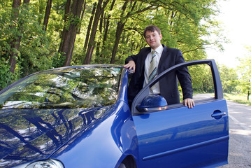 Man in suit ready to drive new car