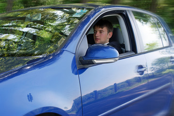 Man in suit driving modern car