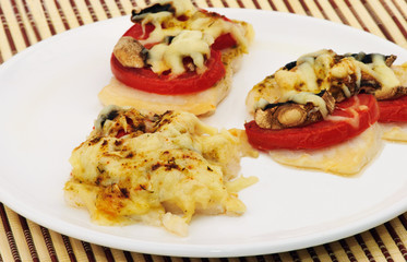 Delicious fish Pangasius with tomatoes, mashrooms and cheese
