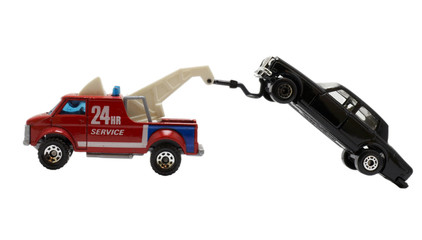 The toy trail truck dragging a car.