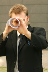 man looking through paper