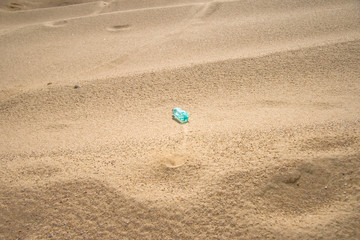 Fototapeta na wymiar A bottle of water in a desert
