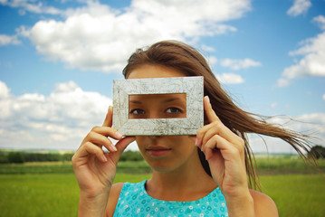 A beautiful young woman creates a frame