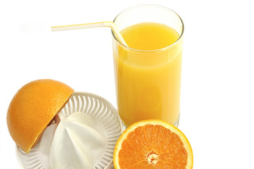 Juicer with slices of  orange and glass of  fresh juice isolated