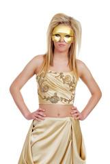 blond woman in gold with hands on hips