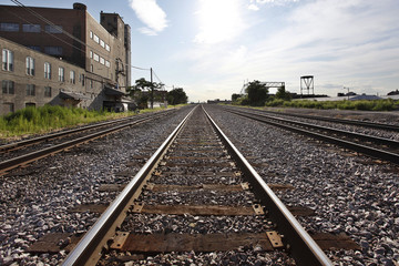 Fototapeta na wymiar Train tracks along industrial area