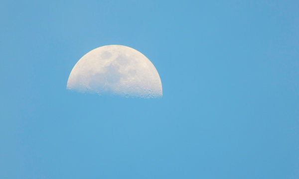 isolated moon in the blue sky