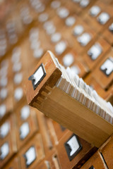 Old wooden card catalogue with one opened drawer