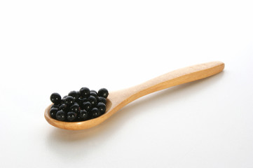 elderberries on a timber spoon