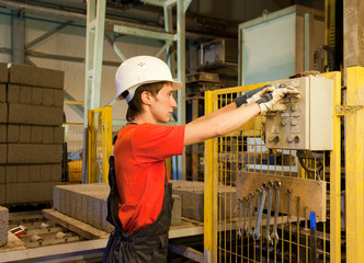 Factory worker fixing broken device