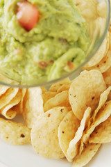 Guacamole (chips in focus)