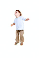 happy young boy jumping over white