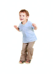 happy young boy jumping over white