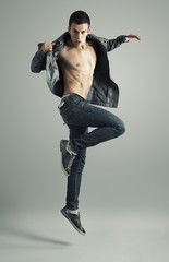 Cool looking young man jumping