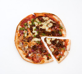 Pizza with slice isolated against white background